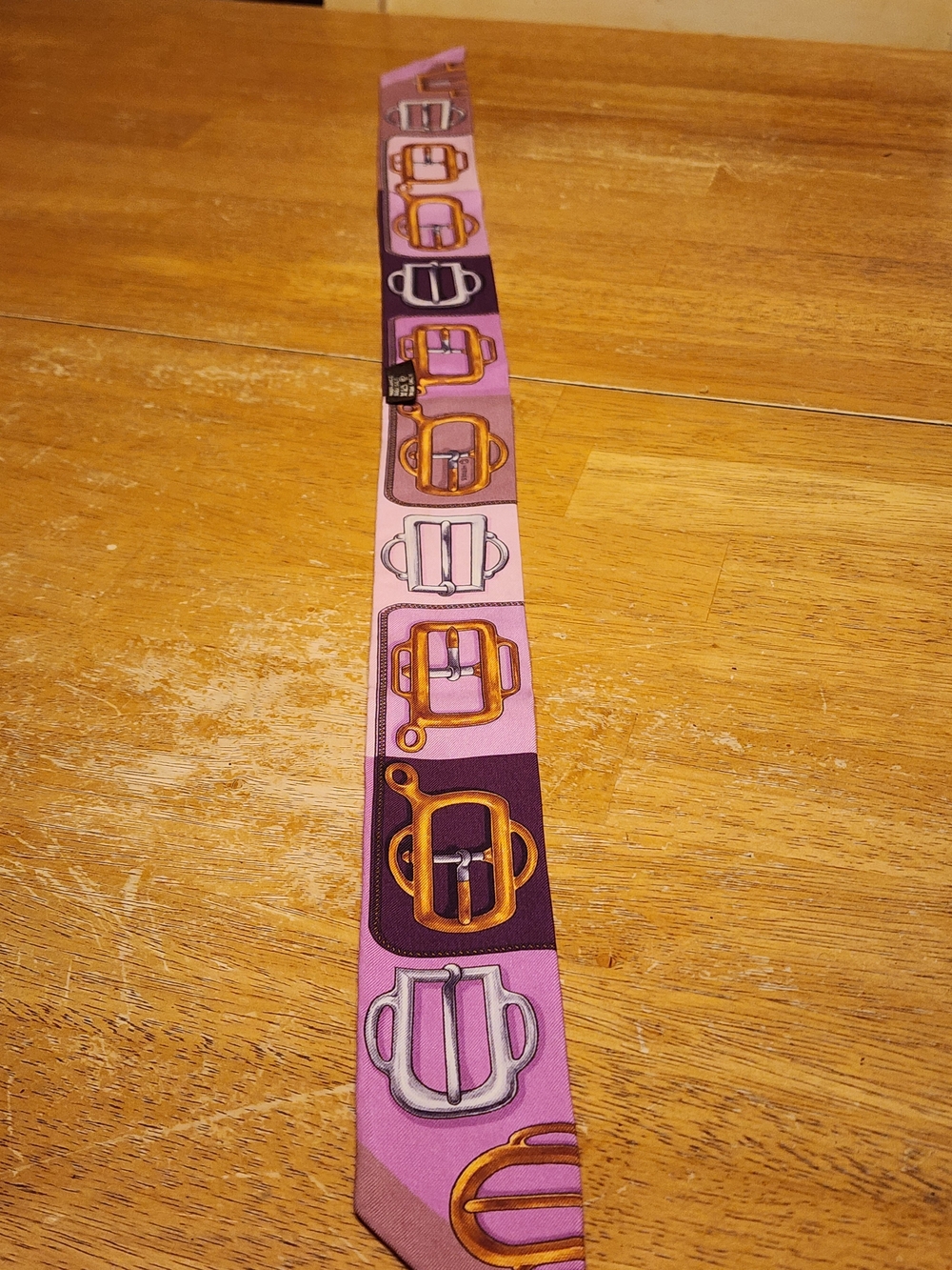 an Hermès Bouclerie d'Attelage Silk Twilly Scarf